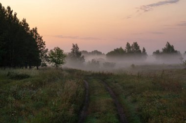 Güneşli puslu bir ışıkta gölün üzerinde sessiz bir şafak. Sonbahar zamanı.