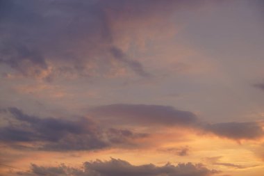 Gün batımında parlayan parlak ışık bulutlarıyla güzel bir akşam masmavi gökyüzü. Gün batımında sıcak bir yaz akşamı. Parlak gün batımı.