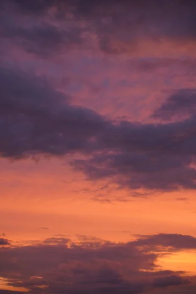 stock image Beautiful evening blue sky at sunset with flaming bright light clouds. A warm summer evening at sunset. Bright sunset.