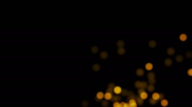 Parlayan bulanık ışıklar arka plan, siyah arka plan üzerinde sarı ışık ve parçacıklar sürüsü