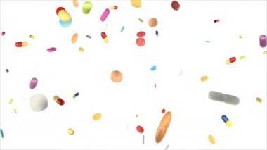 Farklı renkli haplar ve ilaçlar aşağı düşen, beyaz arka plan üzerinde. 