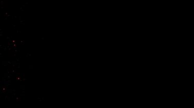 Siyah arka plan üzerinde kırmızı parlayan küreler ve parçacıklar sürüsü.