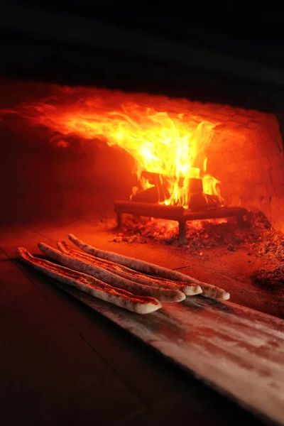 Turkish pide is cooked in a wood-fired oven