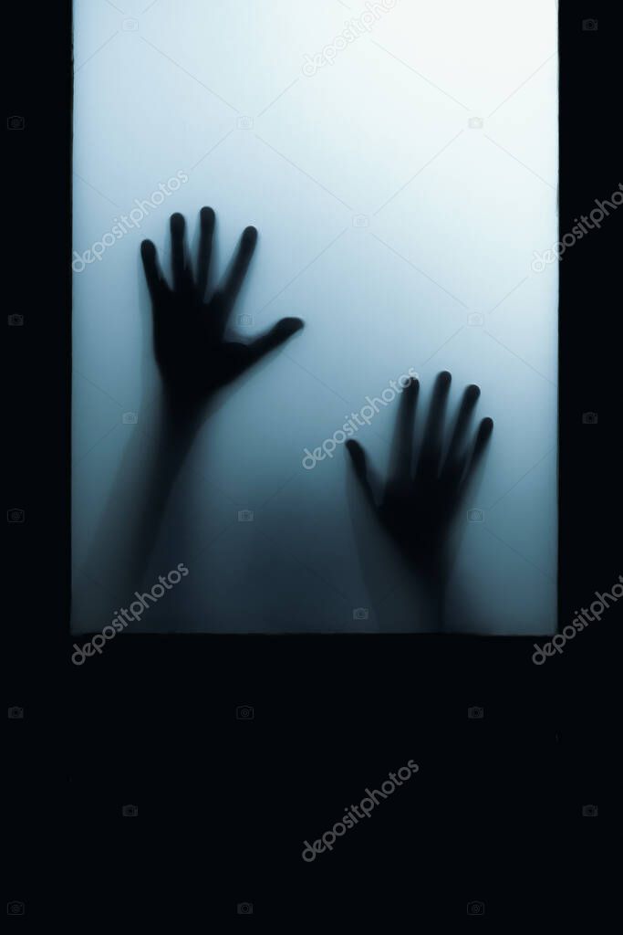 shadow of hand touch behind frosted glass door