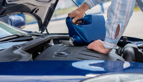 Changing the engine oil, servicing the car, pouring oil into the engine