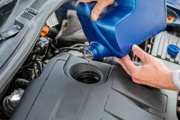 Changing the engine oil, servicing the car, pouring oil into the engine