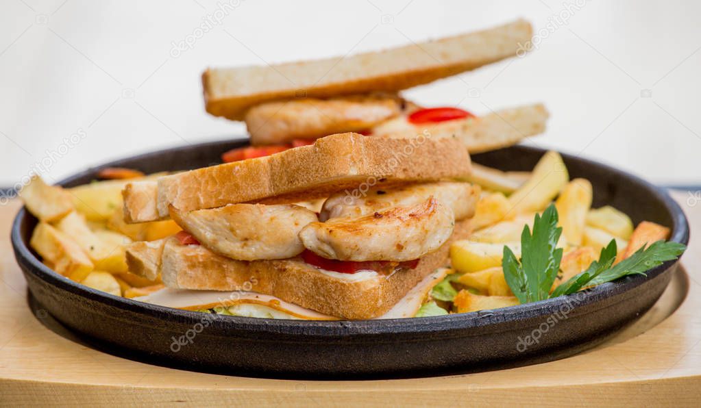 Chicken sandwich in toast bread, with French fries as a bowl, on a white background, restaurant, served