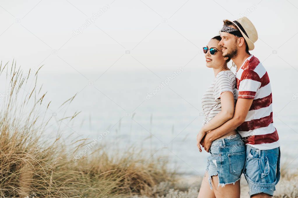 Young loving couple walking on the beach
