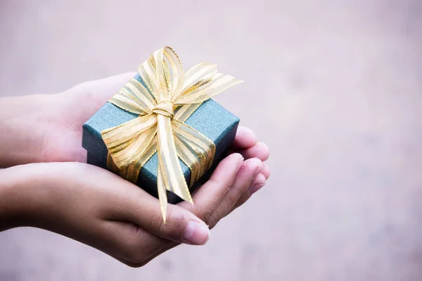 giving gift box in with hands On special days  for special person and copy space background