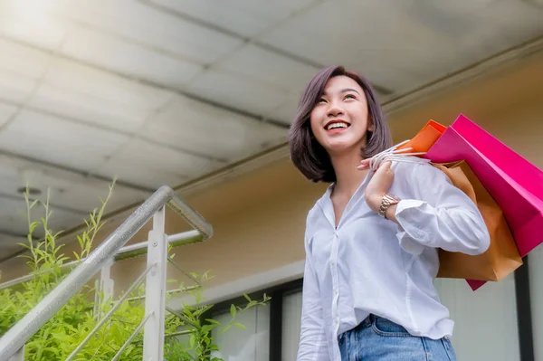 woman smiling and hold shopping bug , she happy time on the day mid year sale