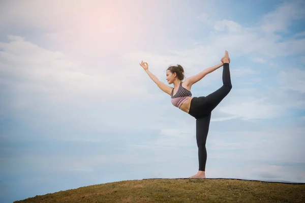 yoga girl In the morning time on blue sky background Strengthen