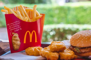 Udon Thani , Thailand , 20 May 2018 in the mcdonald's Restaurant Udon Thani , fast food restaurant Fast Food Sales a hamburger French fries nuggets and beverage in the shop clipart