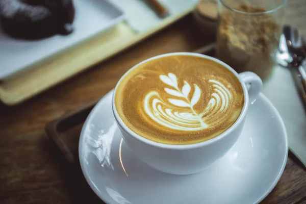 Coffee aroma latte cup in the wood table cafe style — Stock Photo, Image