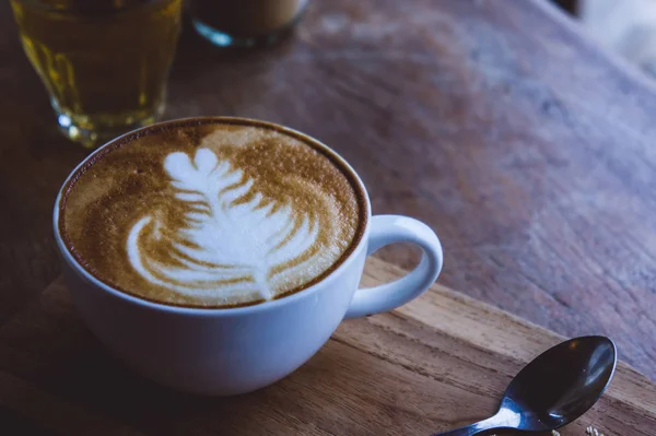 Coffee hot drink cappucino latte art on wood vintage table , cof — Stock Photo, Image