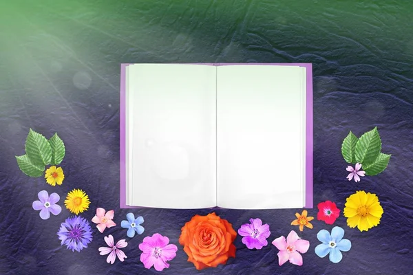Beautiful decoration flowers frame with notepad in center on blue rough stucco background.