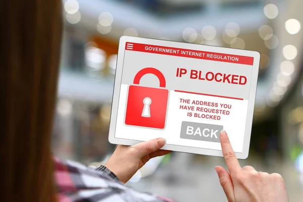 IP address blocked concept, girl with tablet pc on blurred mall background
