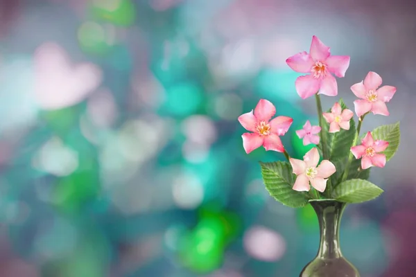 Beautiful live clematis bouquet bouquet in ceramic vase on sunny day with empty space for your content on tree leaves blurred bokeh background.