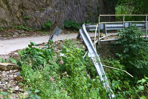 mountain road with broken fence after the terrible car accident, industrial transportation image