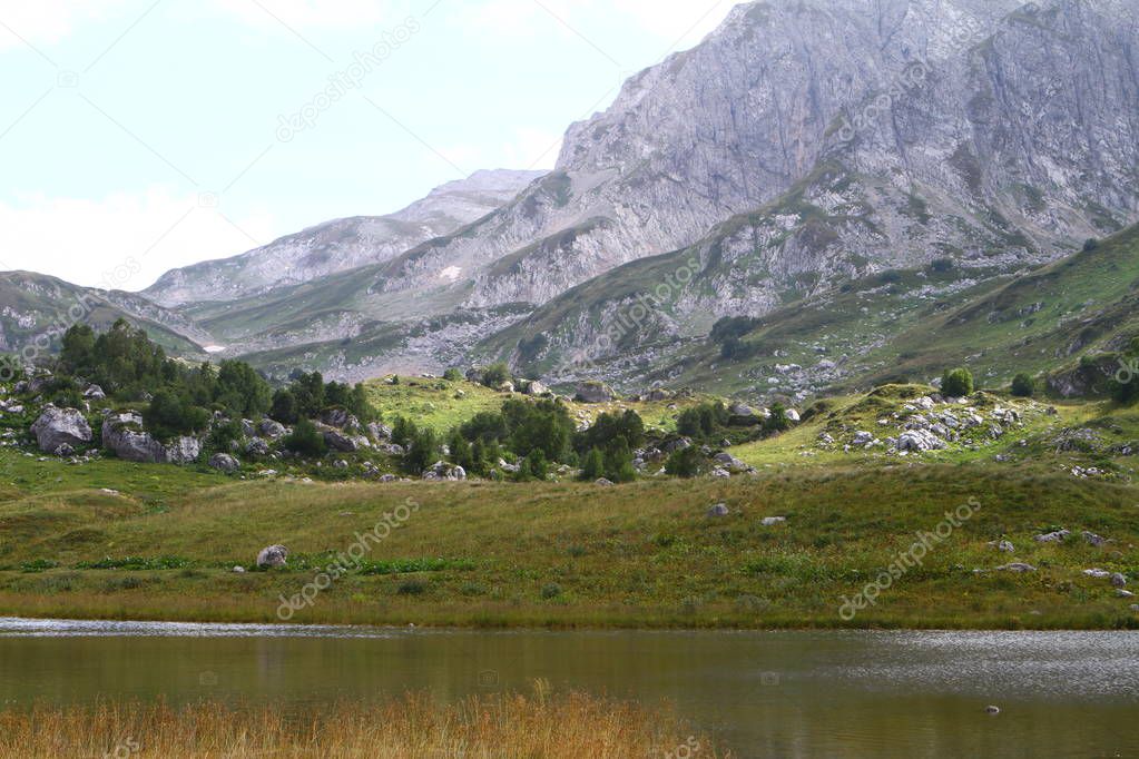 Natural landscape photo of small mountain lake Psenodah in North Caucasus near Fisht and Oshten mountains