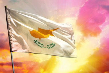 Kıbrıs bayrağı güzel renkli günbatımı veya gündoğumu arka planda çırpınan. Kıbrıs başarı ve mutluluk kavramı.