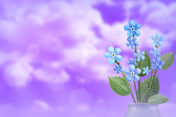 Beautiful live forage bouquet bouquet in porcelain vase on sunny day with empty space for your content on cloudy sky background.