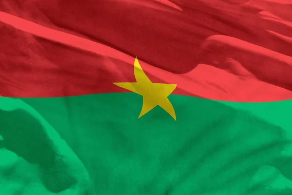 Acenando bandeira de Burkina Faso para usar como textura ou fundo, a bandeira está agitando no vento — Fotografia de Stock