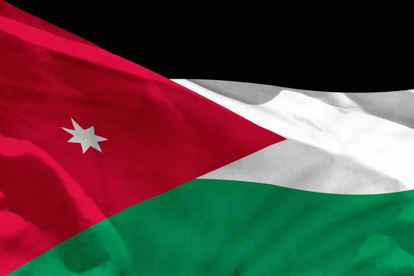 Ondeando la bandera de Jordania para usar como textura o fondo, la bandera está ondeando en el viento —  Fotos de Stock