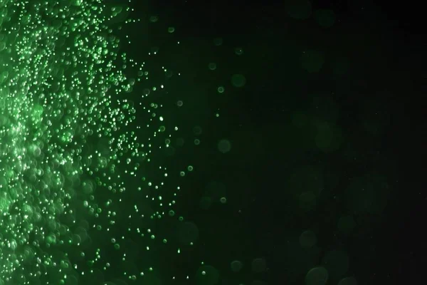 Verde enorme quantidade voando espumantes festivos bokeh textura - bonito abstrato foto fundo — Fotografia de Stock