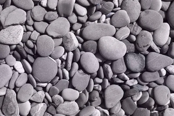 Droge rivier Shore Pebbles textuur-schattige abstracte foto achtergrond — Stockfoto