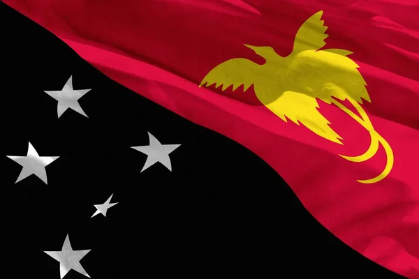 Ondeando la bandera de Papúa Nueva Guinea para usar como textura o fondo, la bandera está ondeando en el viento — Foto de Stock