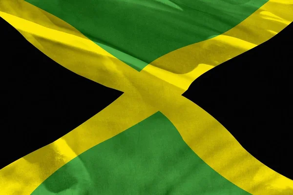 Doku veya arka plan olarak kullanmak için Jamaika bayrağı sallayarak, bayrak rüzgar da çırpınıyor — Stok fotoğraf
