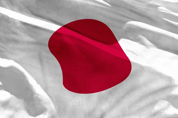 Sventolando la bandiera giapponese per l'utilizzo come texture o sfondo, la bandiera sventola sul vento — Foto Stock