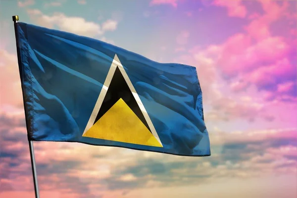 Ondeando la bandera de Santa Lucía sobre el colorido fondo nublado del cielo. Concepto de prosperidad . —  Fotos de Stock