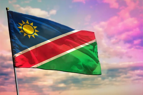 Flattering Namibië vlag op kleurrijke bewolkte hemel achtergrond. Welvaart concept. — Stockfoto