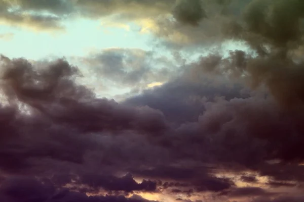 nice unreal toned fantasy sun colored clouds in the sky for using in design as background.
