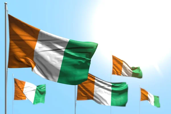 Pretty 5 flags of Cote d Ivoire are waving against blue sky picture with bokeh - any celebration flag 3d illustration — Stock Photo, Image