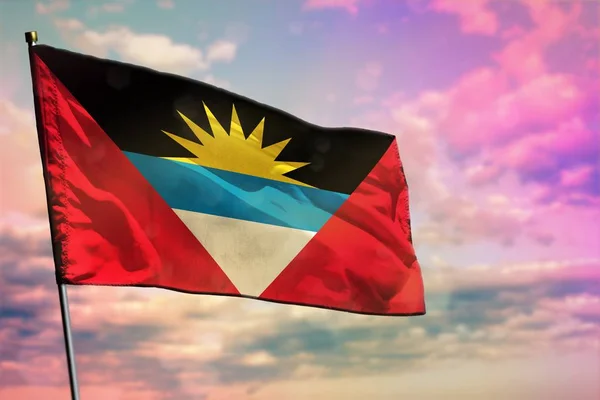 Fluttering Antigua and Barbuda flag on colorful cloudy sky background. Prosperity concept. — Stock Photo, Image