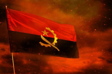 Kırmızı gökyüzünde Angola bayrağı dalgalanırken duman sütunları arka planda. Sorunlar kavramı.