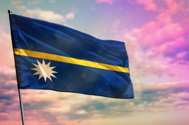 Renkli bulutlu arka planda dalgalanan Nauru bayrağı. Nauru refah konsepti.