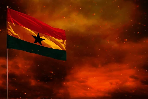 Fluttering Ghana flag mockup with blank space for your data on crimson red sky with smoke pillars background. Ghana problems concept.