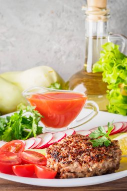 Kıyılmış biftek pirzola turp kiraz domates dilim salatalık maydanoz limon ve sosu ketçap kavramı gıda yaz ev yapımı piknik Barbekü assorty karışımı sebze ile beyaz tabakta ızgarada pişmiş