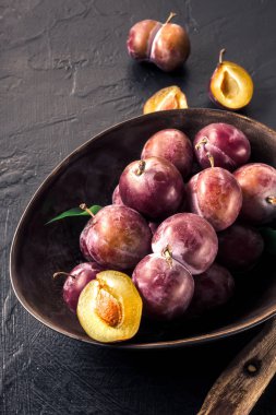 Kendi elleri hasat kopya alanı ile tarım üstten görünüm tarafından bütün taze Olgun kırmızı menekşe mavi Erik ve dilimleri bıçak kase ile mutfak masasında ev yapımı reçel kompostosu pişirme kavramı kesmek yapmak.