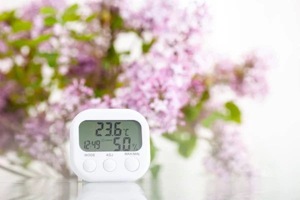 White electronic hygrometer on white table — 스톡 사진