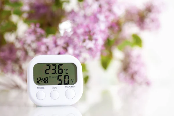 White electronic hygrometer on white table — 스톡 사진