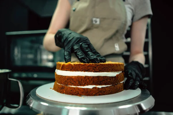 close up shot of woman making a cake in bakery