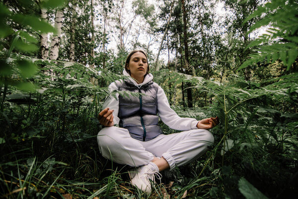 girl meditating in siberian forest