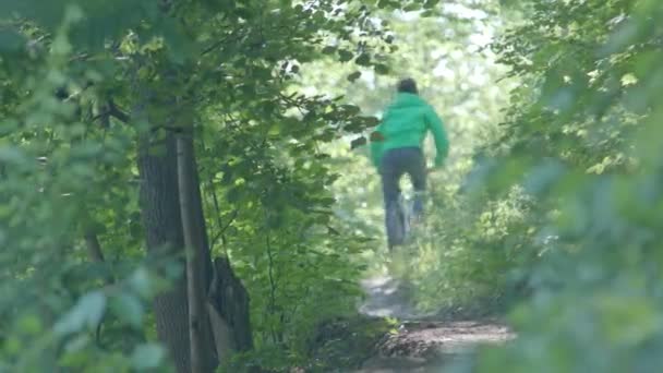 El video de la filmación del niño en la bicicleta en las montañas . — Vídeos de Stock