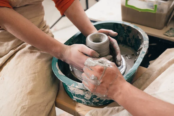 Man and woman hands pottery studying in studio. Creating vase. H