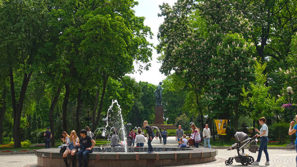 People near the fountain in Kiev in Shevchenko Park on a spring day