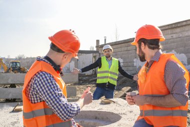 baş adam dinleniyor ve çalışmak istemiyorum kask işçilere bağırıyor